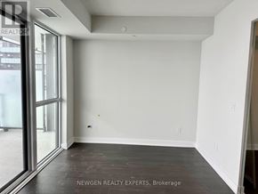 Mississauga (City Centre) condo for rent - A room with a window and a door is empty and waiting to be furnished.