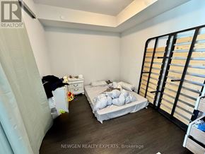 Mississauga (City Centre) condo for rent - A bedroom with a bed, dresser, and wardrobe.