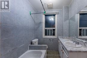 Toronto (Dovercourt-Wallace Emerson-Junction) triplex for rent - A bathroom with a toilet, sink, and tub.