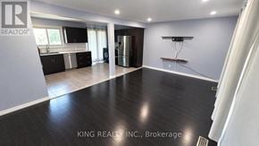 London East (East C) apartment for rent - A spacious kitchen with dark wood flooring and modern appliances.