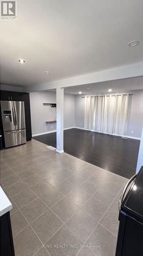 London East (East C) apartment for rent - A kitchen with a black fridge and a black trash can.