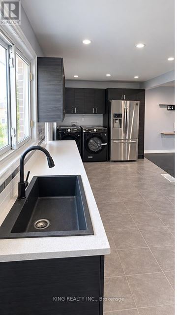 London East (East C) apartment for rent - A modern kitchen with a sink and a refrigerator.