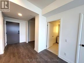 Mississauga (City Centre) condo for rent - A hallway with a door on the left and an open door on the right.