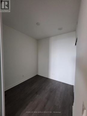Mississauga (City Centre) condo for rent - A room with a wooden floor and white walls.