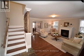 Niagara-On-The-Lake (Town) apartment for rent - A living room with a fireplace and a staircase.