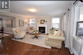 Niagara-On-The-Lake (Town) apartment for rent - A living room with a fireplace and two chairs.