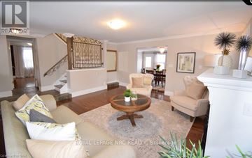 Niagara-On-The-Lake (Town) apartment for rent - A living room with a beige couch and a wooden coffee table.