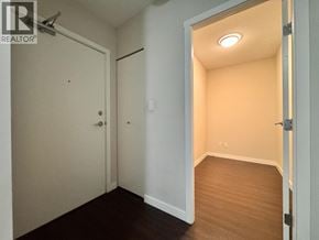 Vancouver apartment for rent - A hallway with a door on the left and an open door on the right.
