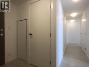 Richmond apartment for rent - A hallway with white doors and a brown door on the left.