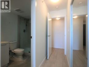 Richmond apartment for rent - A bathroom with a toilet and a doorway leading to another room.