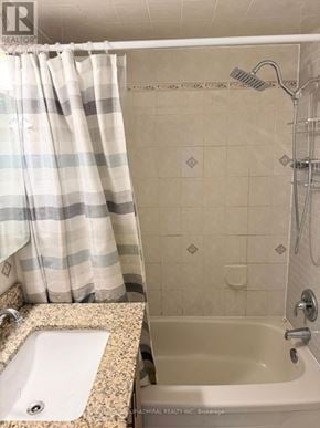 Toronto (Keelesdale-Eglinton West) apartment for rent - A bathroom with a shower curtain, sink, and bathtub.