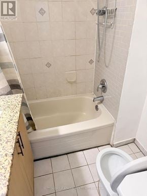 Toronto (Keelesdale-Eglinton West) apartment for rent - A white tiled bathroom with a bathtub and toilet.
