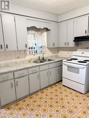 Toronto (Keelesdale-Eglinton West) apartment for rent - A kitchen with white cabinets and a patterned floor.