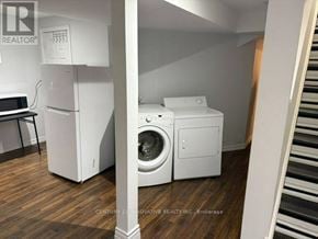 Markham (Cedarwood) apartment for rent - A white washing machine and dryer in a laundry room.