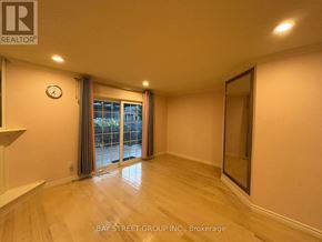 Hamilton (Meadowlands) townhouse for rent - A spacious room with a large window and sliding glass door.