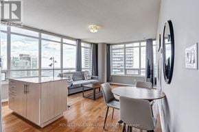 Toronto (Waterfront Communities) condo for rent - A well-lit living room with a dining table and chairs.