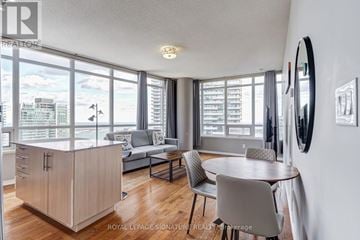 Toronto (Waterfront Communities) condo for rent - A well-lit living room with a dining table and chairs.