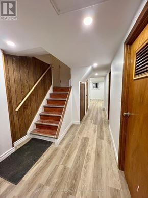 Toronto (Keelesdale-Eglinton West) apartment for rent - A hallway with wooden floors and a staircase with wooden steps and handrail.