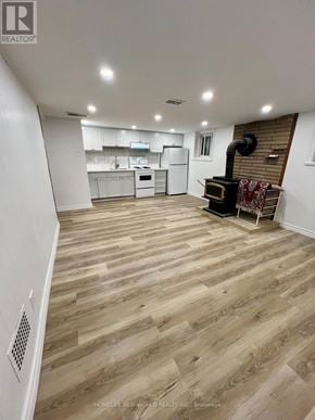 Toronto (Keelesdale-Eglinton West) apartment for rent - A spacious kitchen with wooden flooring and white walls.