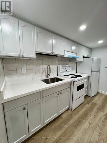 Toronto (Keelesdale-Eglinton West) apartment for rent - A kitchen with white cabinets and appliances.