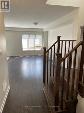Hamilton (Stoney Creek Mountain) townhouse for rent - A hallway with wood floors and a wooden staircase.