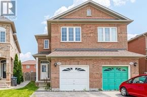 Mississauga (East Credit) apartment for rent - A red car is parked in front of a house with a white garage door.