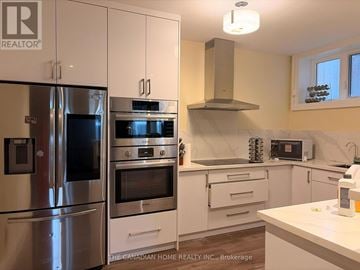 Toronto (Agincourt South-Malvern West) apartment for rent - A kitchen with a refrigerator, oven, and microwave.