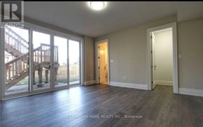 Toronto (Agincourt South-Malvern West) apartment for rent - A room with a wooden floor and a sliding glass door leading to a deck.