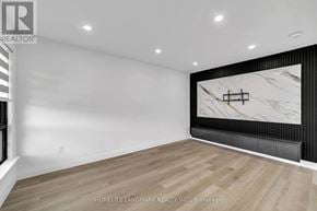 Toronto (Kennedy Park) apartment for rent - A spacious room with wooden flooring and a marble feature wall.