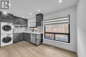 Toronto (Kennedy Park) apartment for rent - A modern kitchen with a washing machine and a window.