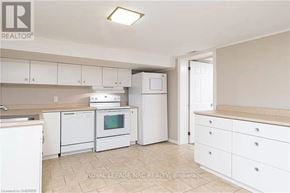 Milton (Mn Milton North) apartment for rent - A white kitchen with a microwave, oven, and dishwasher.