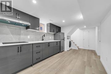 Toronto (Kennedy Park) apartment for rent - A modern kitchen with wooden floors and grey cabinets.
