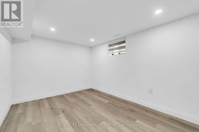 Toronto (Kennedy Park) apartment for rent - A room with wooden flooring and white walls, with a logo for REALTOR® in the top left corner.