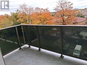 Toronto (Glenfield-Jane Heights) apartment for rent - A balcony with glass railings overlooking a residential area.