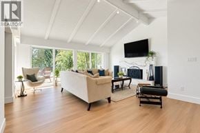 West Vancouver apartment for rent - A living room with a white couch and a television mounted on the wall.