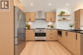 West Vancouver apartment for rent - A modern kitchen with wooden cabinets and stainless steel appliances.