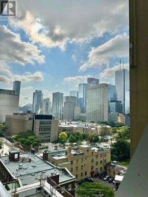 Toronto (Kensington-Chinatown) condo for rent - A cityscape with buildings and a cloudy sky.