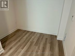 Toronto (Kensington-Chinatown) condo for rent - A room with wooden flooring and white walls.