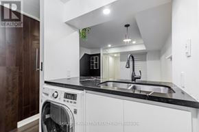 Toronto (Willowdale East) townhouse for rent - A modern kitchen with a washer and dryer built into the counter.