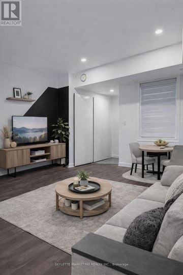 Toronto (Willowdale East) townhouse for rent - A modern living room with a grey sofa and a wooden coffee table.