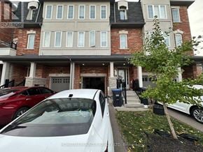 Brampton (Heart Lake East) townhouse for rent - A white car is parked in front of a brick house.