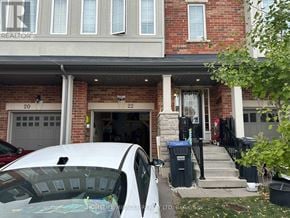 Brampton (Heart Lake East) townhouse for rent - A white car is parked in front of a brick house with a garage.