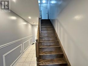 Brampton (Heart Lake East) townhouse for rent - A long flight of wooden stairs leads to a door at the top.