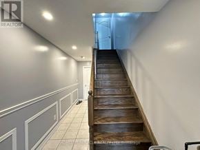 Brampton (Heart Lake East) townhouse for rent - A long wooden staircase with a metal railing.
