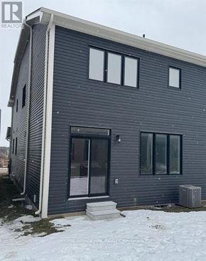 Welland (Dain City) apartment for rent - A grey house with a white door and windows.