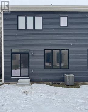 Welland (Dain City) apartment for rent - A grey house with a black door and windows.