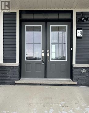 Welland (Dain City) apartment for rent - A black door with a glass window and a sign on the wall.