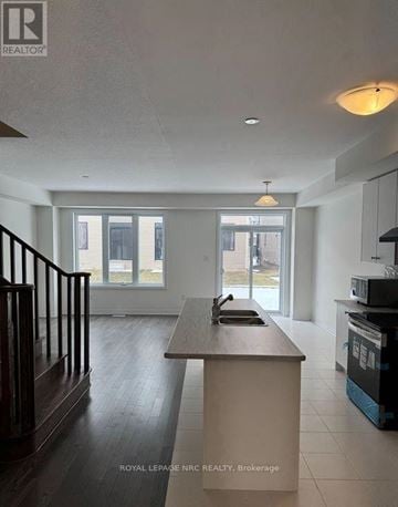 Welland (Dain City) apartment for rent - A kitchen with a counter and a stove top oven.