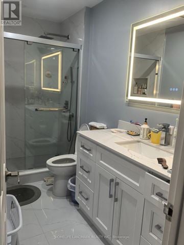 Toronto (Pleasant View) apartment for rent - A bathroom with a toilet, sink, and mirror.