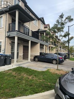 Brampton (Credit Valley) townhouse for rent - A black car is parked in front of a building with a balcony.